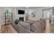 Spacious living room features a fireplace, TV, decorative shelving, and a comfortable gray sofa at 372 Natsam Woods Way, Wake Forest, NC 27587
