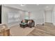 Inviting living area with comfortable sofa, ottoman, large windows, and modern decor at 372 Natsam Woods Way, Wake Forest, NC 27587