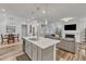 Open concept living space with kitchen island, dining area and living room featuring a fireplace at 372 Natsam Woods Way, Wake Forest, NC 27587