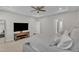 Spacious bedroom featuring a ceiling fan, carpeted floors, TV and neutral paint providing a calming atmosphere at 372 Natsam Woods Way, Wake Forest, NC 27587