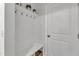 Functional mudroom offers coat hooks, a bench with storage, and a clean, white aesthetic at 372 Natsam Woods Way, Wake Forest, NC 27587