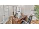 Comfortable office space featuring a modern desk, a black office chair and hardwood flooring at 372 Natsam Woods Way, Wake Forest, NC 27587