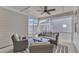 Relaxing screened porch featuring comfortable seating, a ceiling fan, and a stylish patterned rug at 372 Natsam Woods Way, Wake Forest, NC 27587