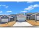 A charming street view of newly constructed townhomes with attached garages on a sunny day at 372 Natsam Woods Way, Wake Forest, NC 27587