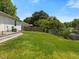 This exterior image shows a sprawling, well-maintained lawn with fencing in the backyard at 4 Hannah Ct, Durham, NC 27713