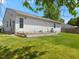 A ranch style home with a wooden porch and a large grassy backyard under a blue sky at 4 Hannah Ct, Durham, NC 27713