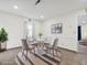 Bright dining area features a round table, four chairs, neutral decor, and a striped rug at 4 Hannah Ct, Durham, NC 27713