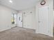 Cozy entryway with carpet flooring, welcome mat, and a storm door that lets in natural light at 4 Hannah Ct, Durham, NC 27713