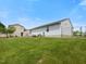 Exterior view features a side yard with green grass, a fence and the side of the home at 4 Hannah Ct, Durham, NC 27713