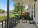 Cozy covered front porch with decorative woodwork and view of the front lawn at 4 Hannah Ct, Durham, NC 27713