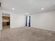 Spacious living area with neutral carpet and large windows with good light and neutral color palette at 4 Hannah Ct, Durham, NC 27713
