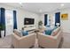 Bright living room featuring neutral furniture, blue accents, and plenty of natural light at 4 Hannah Ct, Durham, NC 27713