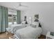 Bright bedroom featuring two twin beds, a window with patterned curtains, and hardwood floors at 4007 Southpoint Landing Way, Durham, NC 27707