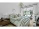 Comfortable bedroom featuring a bed, nightstand, chandelier, and a balcony with outdoor seating at 4007 Southpoint Landing Way, Durham, NC 27707