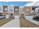 Modern townhome exteriors featuring a mix of stone, wood, and stucco with private balconies and attached garages at 4007 Southpoint Landing Way, Durham, NC 27707