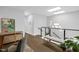 Upstairs hallway with hardwood floors, modern lighting, and a seating bench at 4007 Southpoint Landing Way, Durham, NC 27707