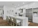 Bright, modern kitchen boasts stainless steel appliances, quartz counters and an island with bar stool seating at 4007 Southpoint Landing Way, Durham, NC 27707
