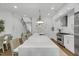 Modern kitchen with long island, stainless steel appliances, and access to the second floor at 4007 Southpoint Landing Way, Durham, NC 27707