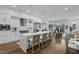 Sleek white kitchen with quartz countertops and an island with seating at 4007 Southpoint Landing Way, Durham, NC 27707