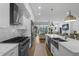 Modern kitchen with stainless steel appliances and an island overlooks the patio and living room at 4007 Southpoint Landing Way, Durham, NC 27707