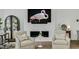 Elegant living room features fireplace with flamingo art above, two chairs, and curated decor at 4007 Southpoint Landing Way, Durham, NC 27707