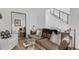 Cozy living room with a comfortable sofa, mirror, and staircase in the background at 4007 Southpoint Landing Way, Durham, NC 27707