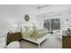 Bright bedroom with a large bed, nightstands, and balcony access with a wooded view at 4007 Southpoint Landing Way, Durham, NC 27707