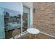 Cozy patio with brick wall, outdoor seating, and a view of modern townhomes at 4007 Southpoint Landing Way, Durham, NC 27707