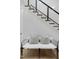 Understated elegant staircase showcasing two throw pillows on the bench at 4007 Southpoint Landing Way, Durham, NC 27707