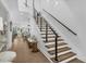 Modern staircase with wood treads, black railings, and cable accents leading to open living spaces at 4007 Southpoint Landing Way, Durham, NC 27707