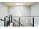 Modern staircase with a skylight, metal railings, and decorative lighting at 4007 Southpoint Landing Way, Durham, NC 27707