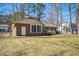Exterior view of a brick home with a large backyard at 411 Colony Woods Dr, Chapel Hill, NC 27517