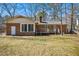 Exterior view of brick home with deck overlooking a large backyard at 411 Colony Woods Dr, Chapel Hill, NC 27517