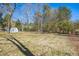 Large backyard with mature trees and utility shed at 411 Colony Woods Dr, Chapel Hill, NC 27517