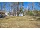 Large backyard featuring a storage shed and mature trees providing ample shade at 411 Colony Woods Dr, Chapel Hill, NC 27517