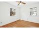 Bright bedroom with hardwood floors, two windows, and ceiling fan at 411 Colony Woods Dr, Chapel Hill, NC 27517