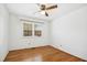 Bedroom with hardwood floors, natural light from double-hung window, and white walls at 411 Colony Woods Dr, Chapel Hill, NC 27517