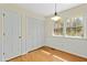 Bedroom with hardwood floors, closet, and natural light from a double-hung window at 411 Colony Woods Dr, Chapel Hill, NC 27517