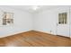 Bedroom with hardwood floors, natural light from window, and door to the yard at 411 Colony Woods Dr, Chapel Hill, NC 27517