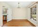Charming dining room highlighting hardwood floors, natural light, and a doorway view into kitchen at 411 Colony Woods Dr, Chapel Hill, NC 27517