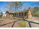 Well-maintained brick house featuring large windows and a neatly landscaped yard at 411 Colony Woods Dr, Chapel Hill, NC 27517