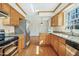 Well-appointed kitchen featuring stainless steel appliances, wooden cabinetry, and granite countertops at 411 Colony Woods Dr, Chapel Hill, NC 27517