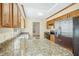 Bright kitchen features granite countertops, stainless steel appliances, and wood cabinets at 411 Colony Woods Dr, Chapel Hill, NC 27517
