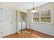 Laundry room features included washer and dryer, shelving and natural light from a window at 411 Colony Woods Dr, Chapel Hill, NC 27517
