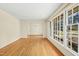 Open living room features gleaming hardwood floors, neutral walls, and large windows offering serene views at 411 Colony Woods Dr, Chapel Hill, NC 27517