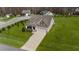 Aerial view of a well-maintained home with a long driveway and large lawn in a wooded neighborhood at 420 Carsons Creek Trl, Wendell, NC 27591