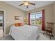 Cozy bedroom with a ceiling fan and large window at 420 Carsons Creek Trl, Wendell, NC 27591