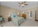 A bedroom features neutral paint, carpeted floors, a ceiling fan, and natural light at 420 Carsons Creek Trl, Wendell, NC 27591