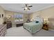A bedroom features a ceiling fan, neutral paint, carpeted floors, and natural light from a window at 420 Carsons Creek Trl, Wendell, NC 27591