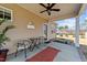 The covered back porch offers outdoor seating, a ceiling fan, and a view of the surrounding yard at 420 Carsons Creek Trl, Wendell, NC 27591